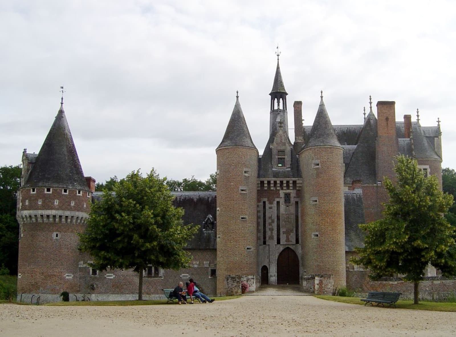 Mur du château du Moulin où des briques vernissées noires dessinent un semis de losanges sur fond rouge